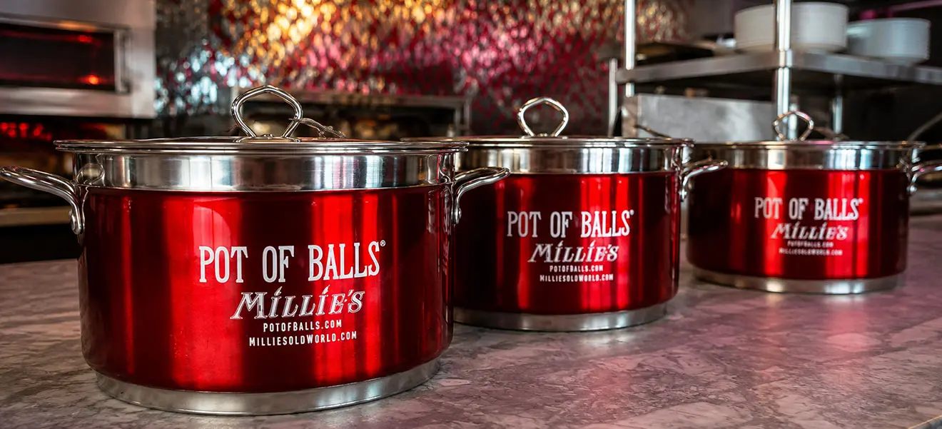 Three red Pot of Balls stockpots in Millie's kitchen