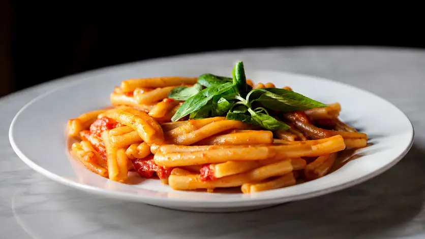 Pasta in vodka sauce topped with fresh basil
