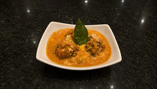 Meatballs in a creamy vodka sauce garnished with basil