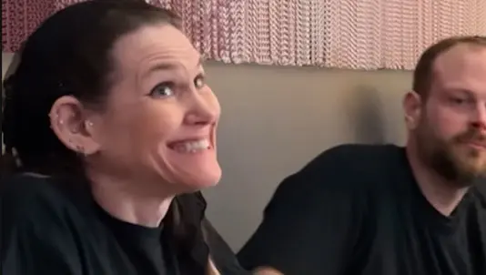 Smiling meatball-eating contest winner in the dining room